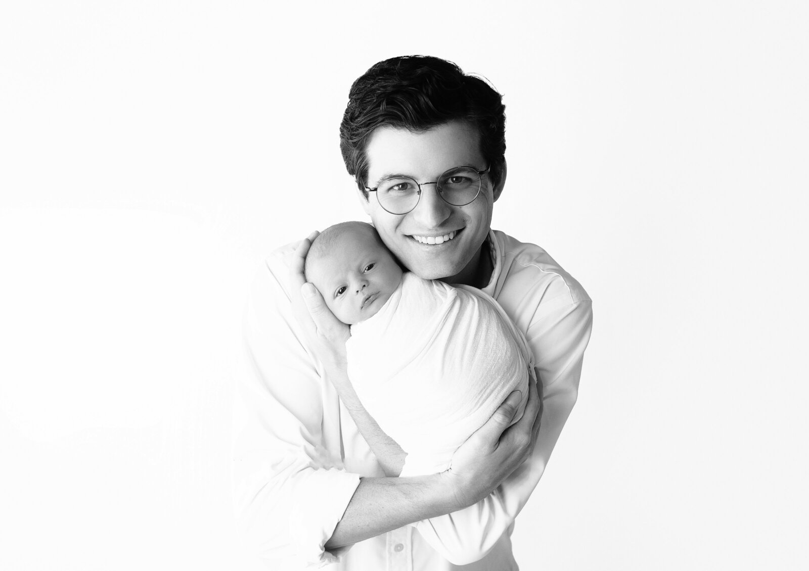 dad holding newborn baby during newborn photoshoot with mt juliet Tennessee photographer 