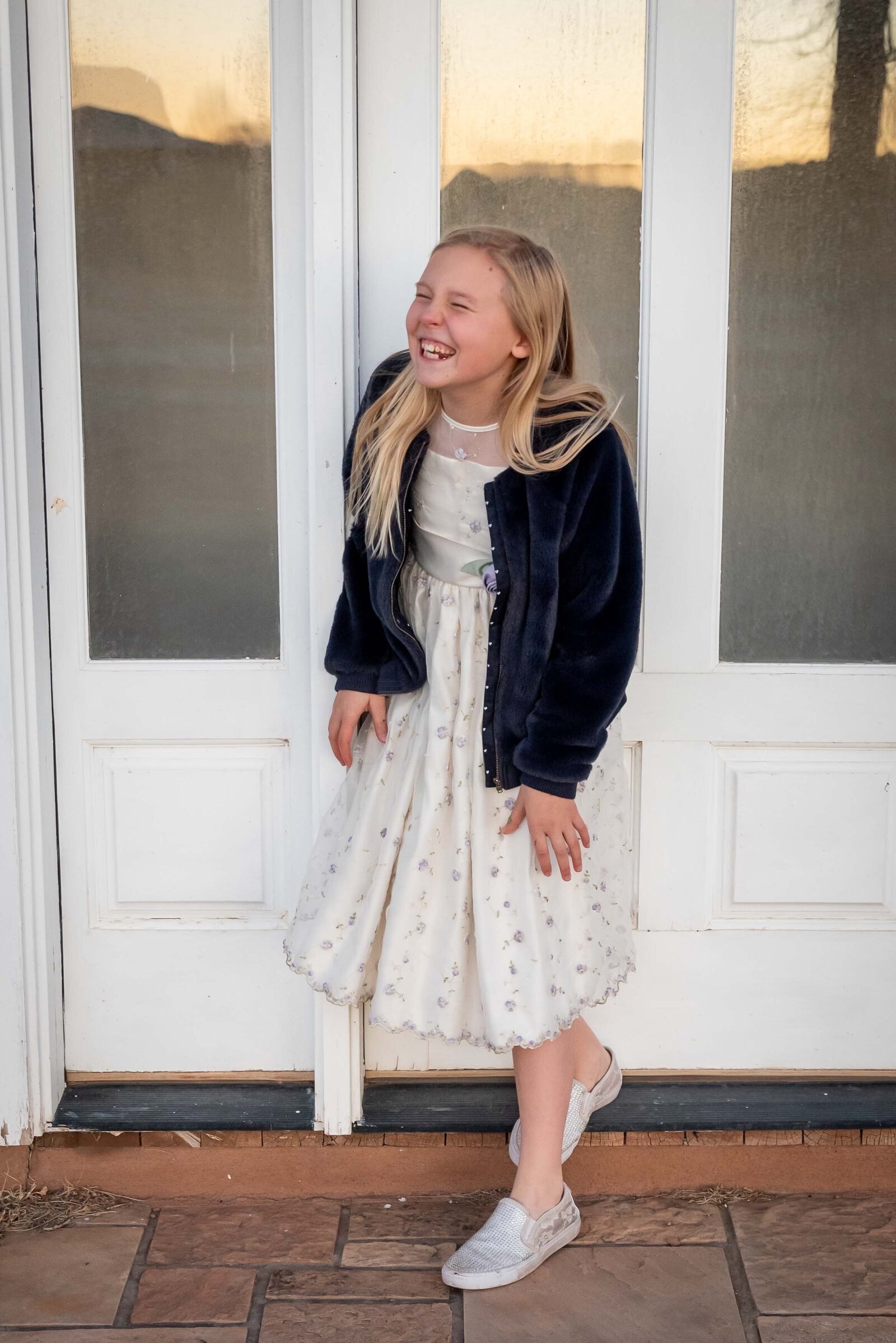 child laughing with white door