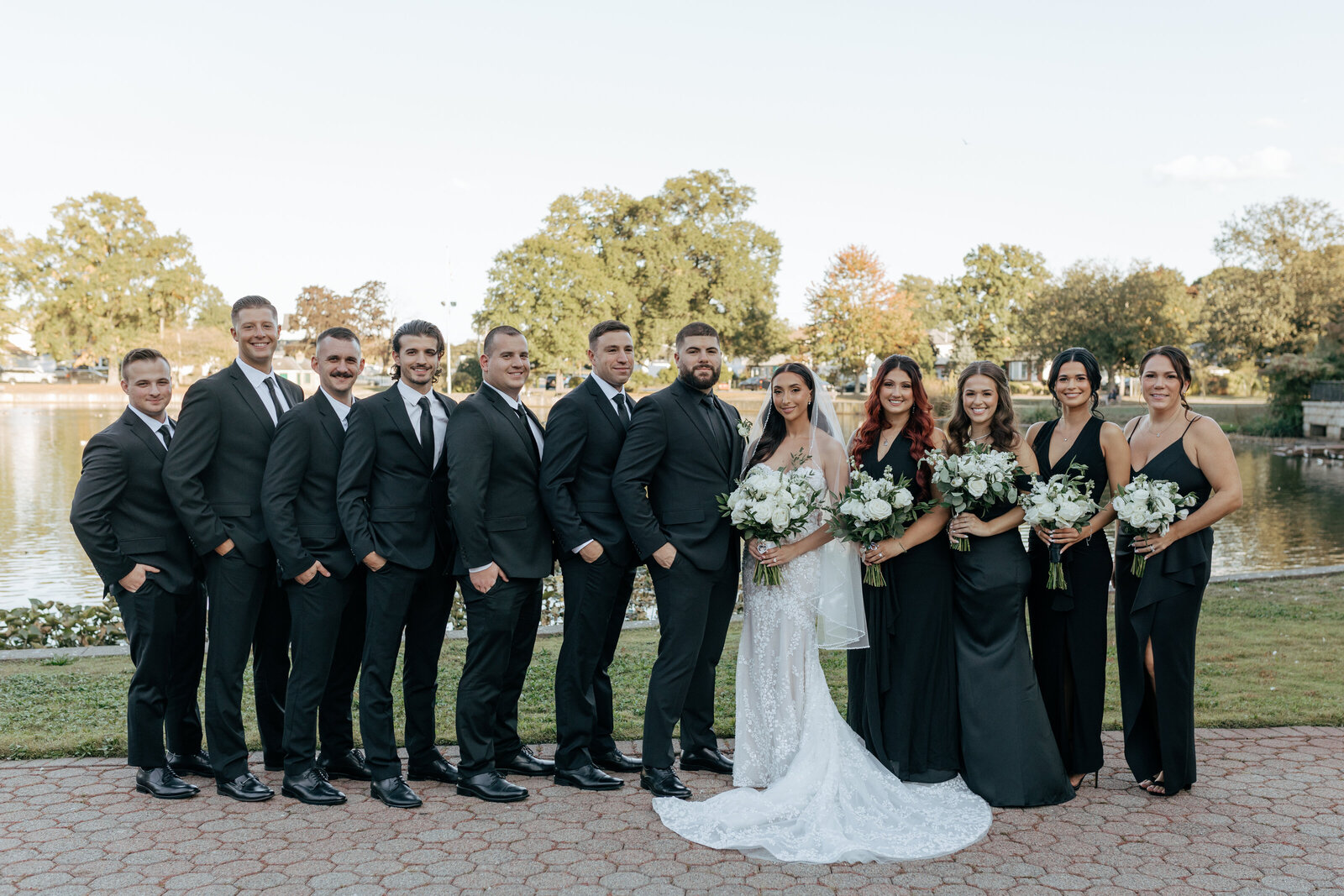 Full bridal party of all black wedding attire excluding bride's white dress | Emma LeeAnn Photography