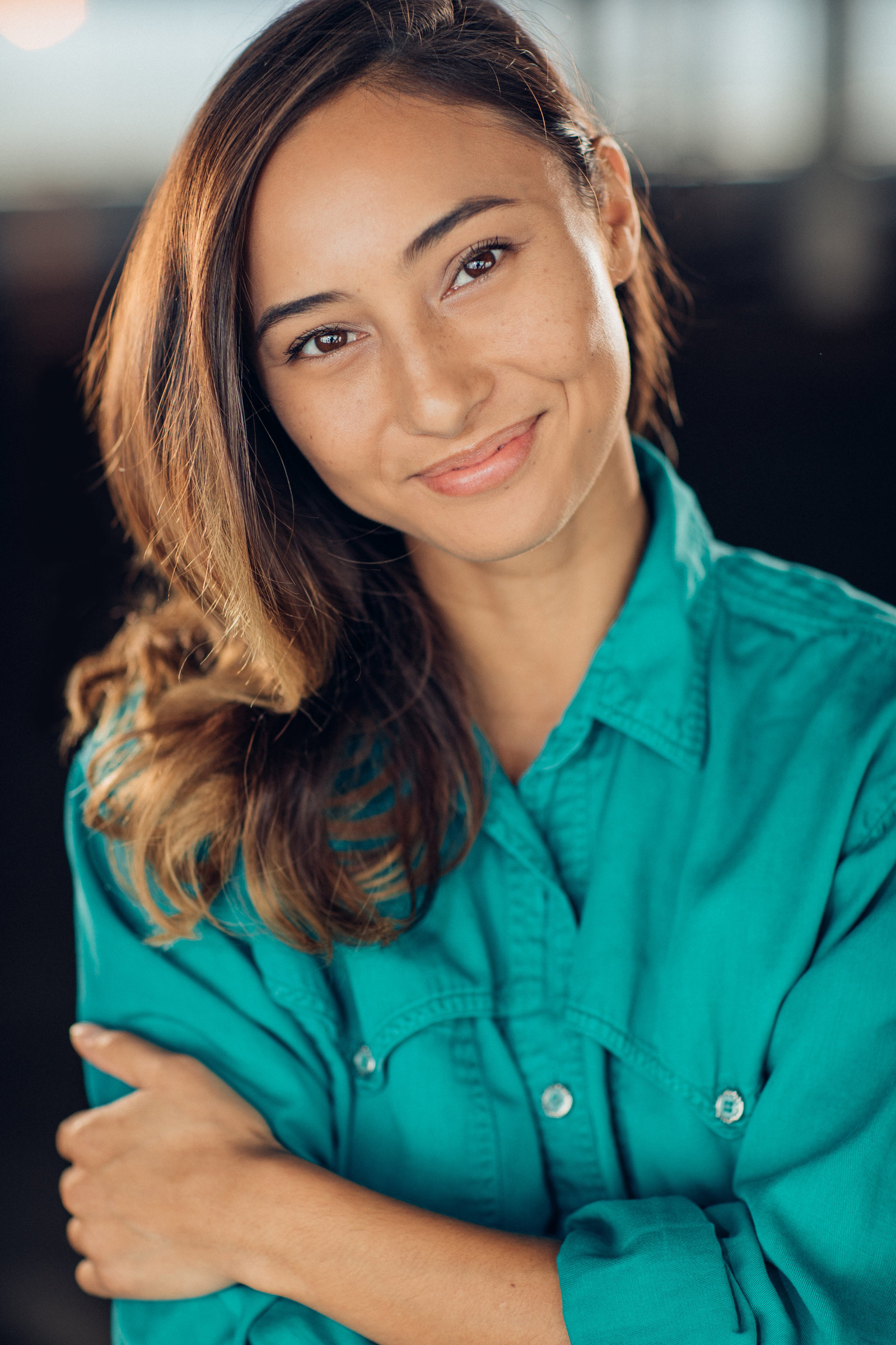 Headshot Photo Of Young Woman In Blue Green Polo