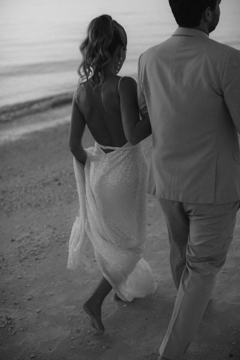 bride and groom running across beach after wedding in fort myers, FL