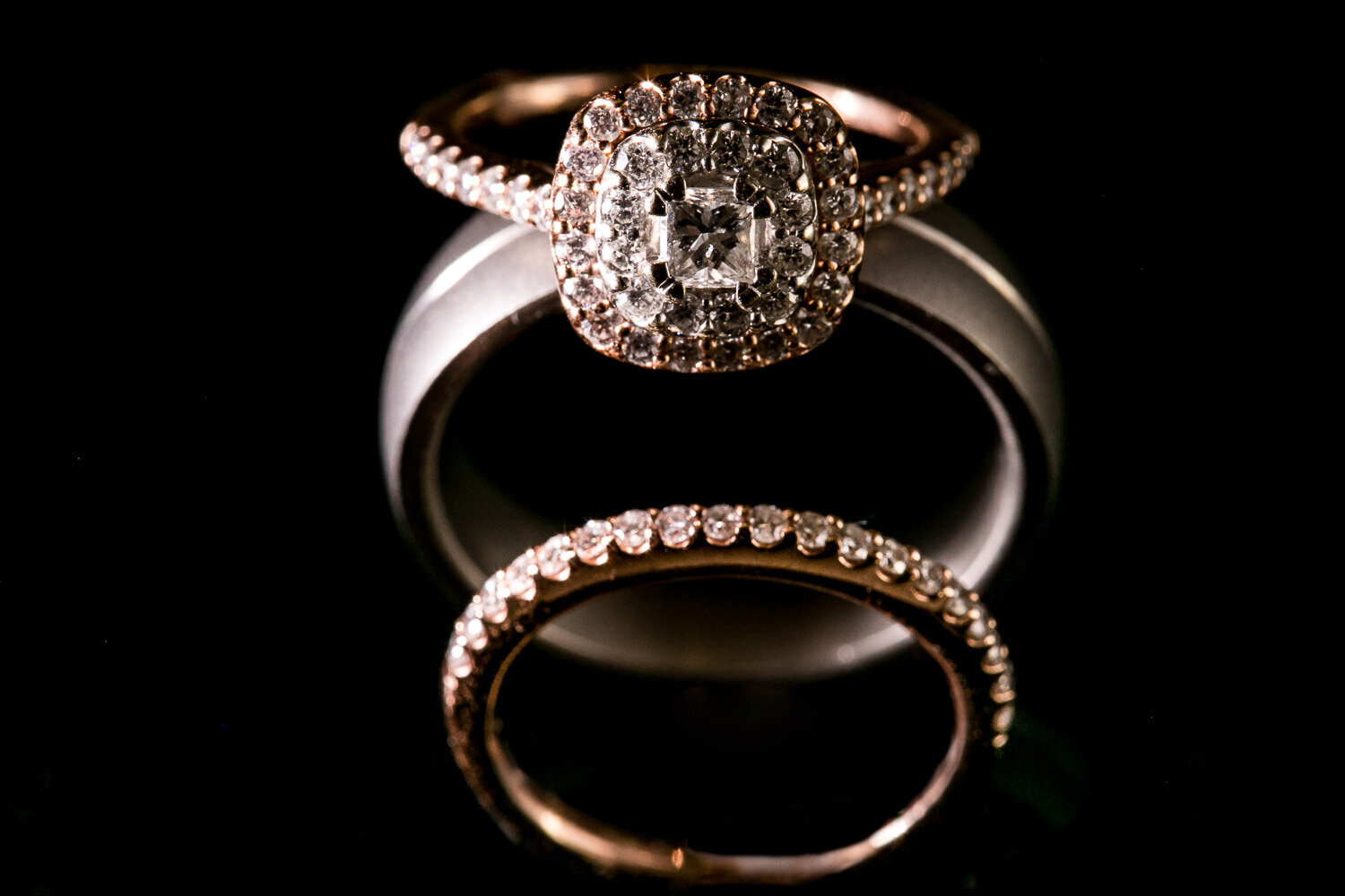 Bride's engagement and wedding ring with groom's ring.