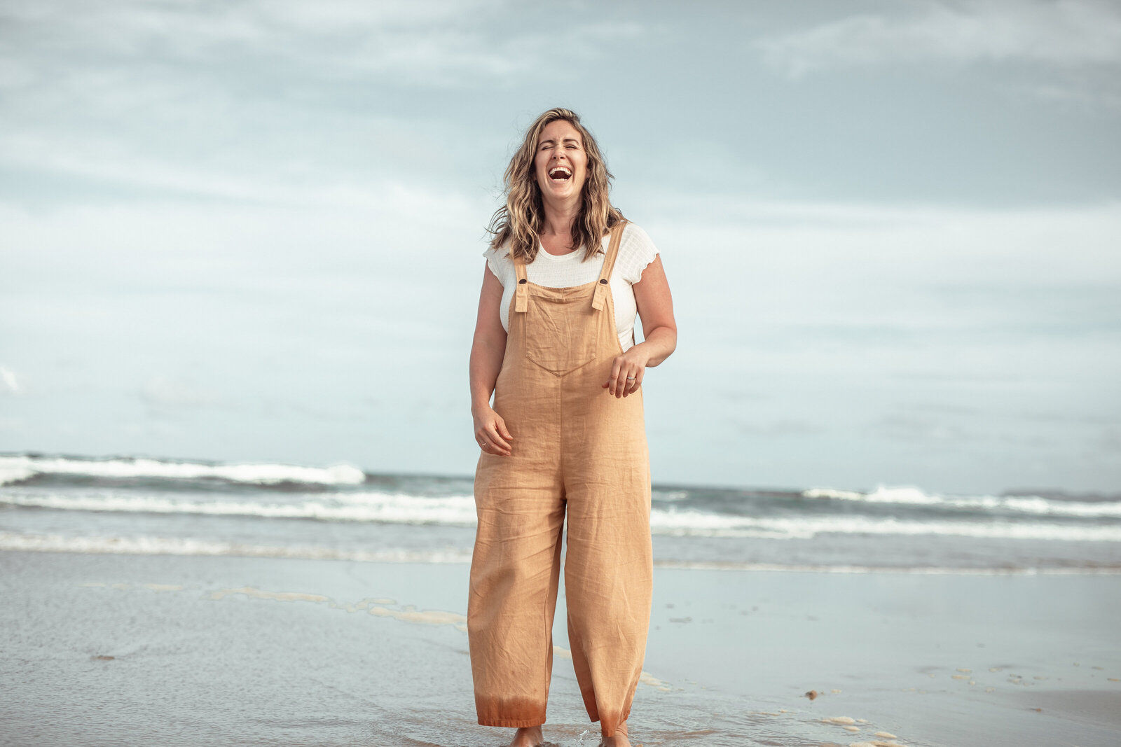 Cheerful woman on beach with a radiant smile