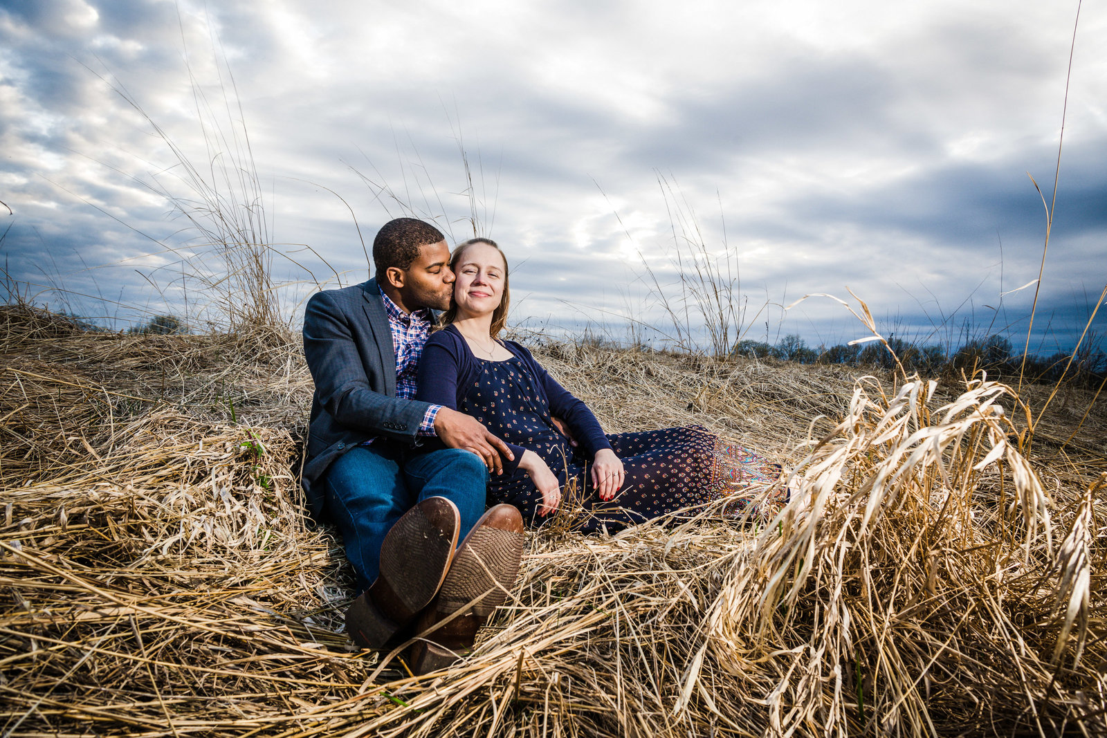 Mixed race couple kiss at sunset