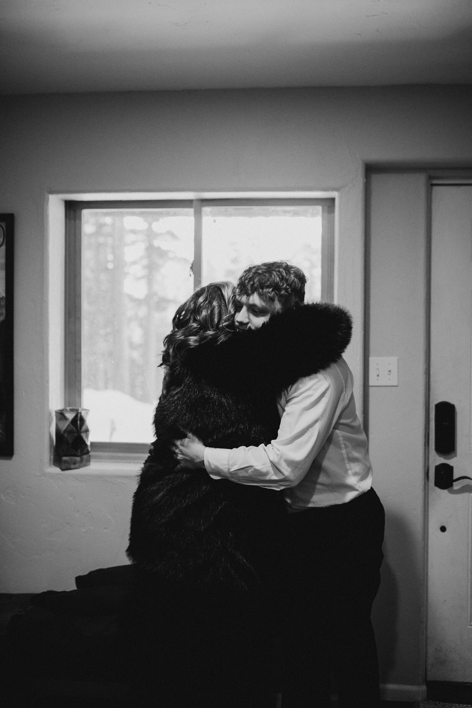 Groom and mother embrace before wedding