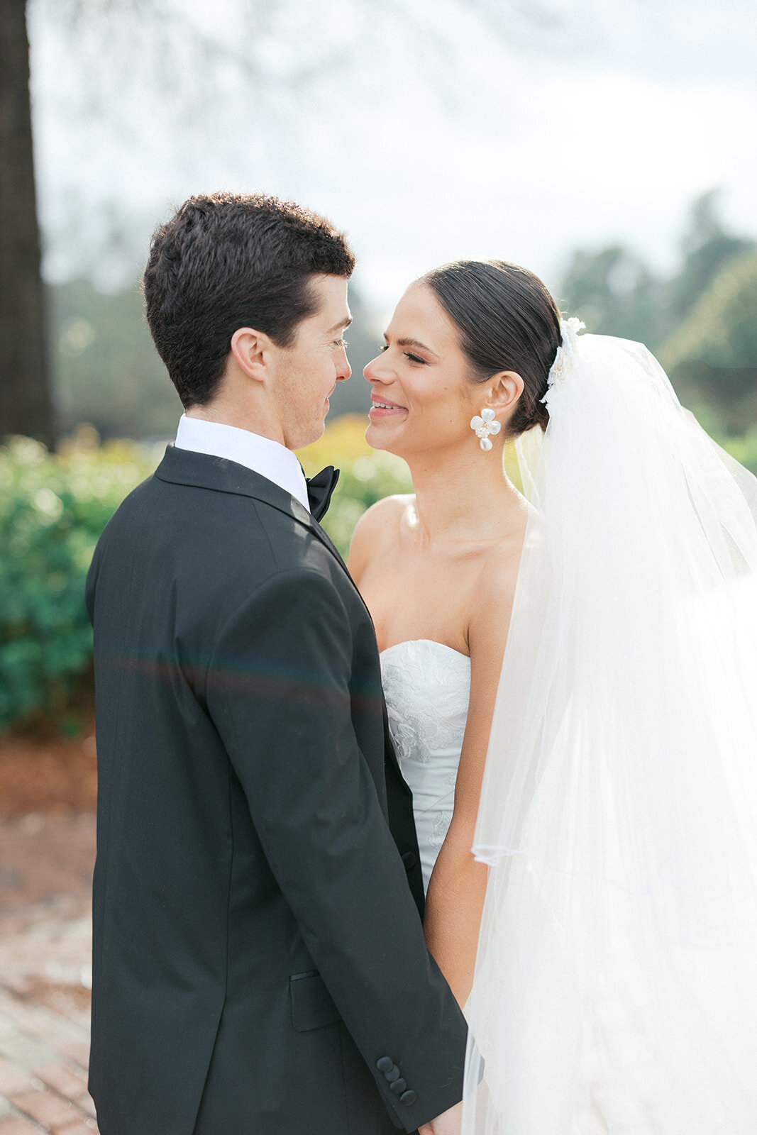 bride and groom look at each others eyes while holding hands