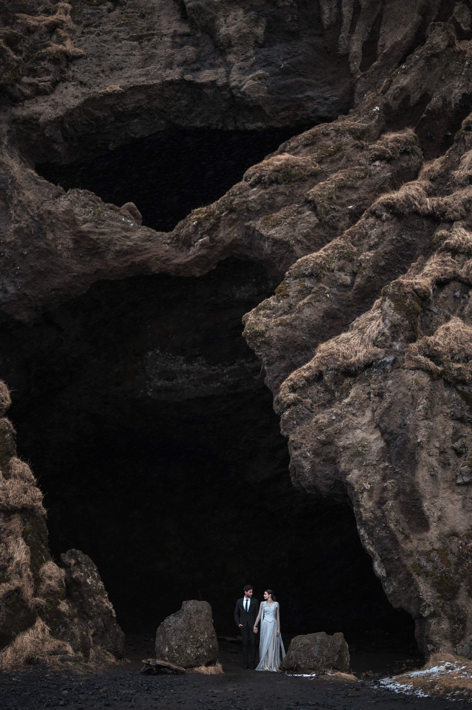 Couple exploring an Icelandic cave after their elopement ceremony