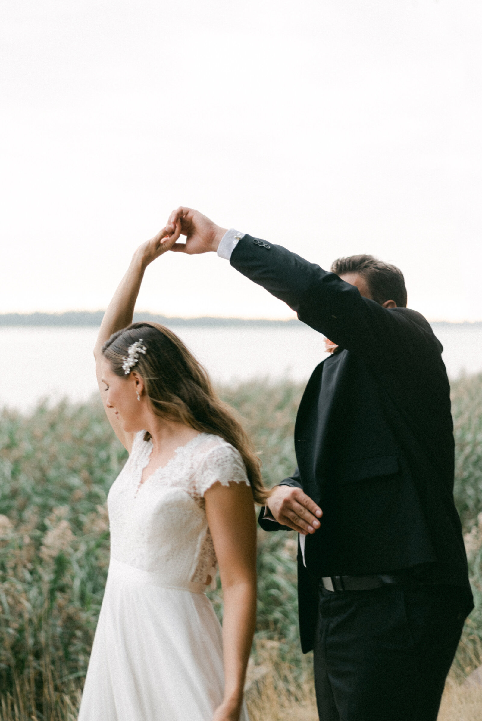 A wedding couple dancing by the sea in Helsinki during their wedding photography with elopement photographer Hannika Gabrielsson.