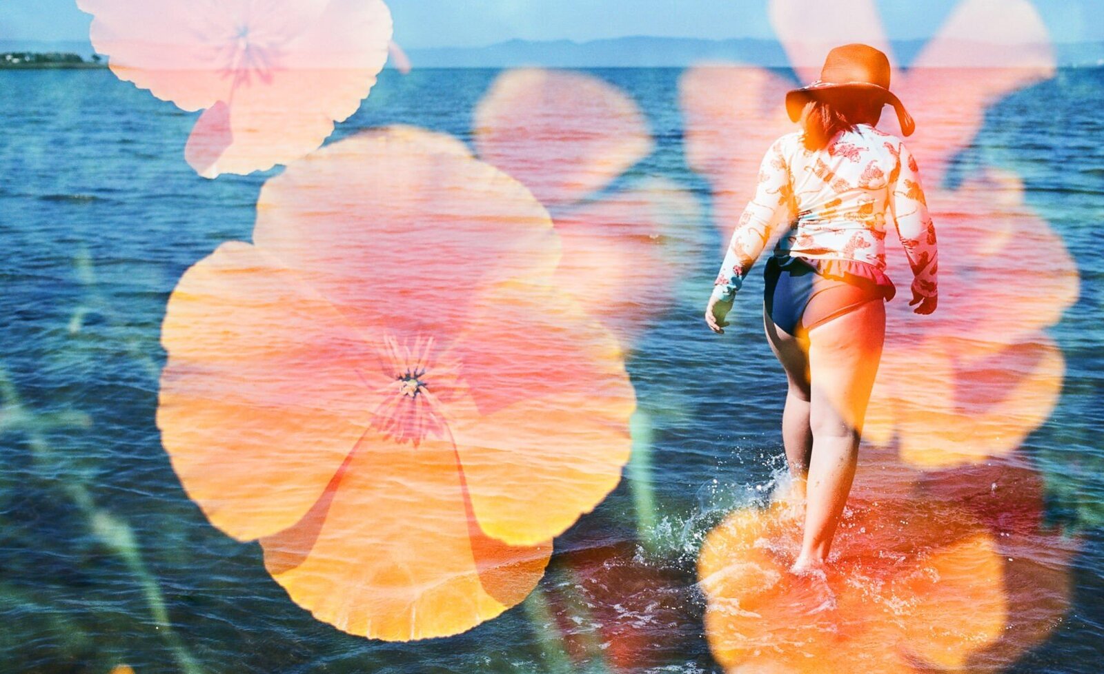 double exposure on film of orange california poppies with a girl walking through shallow water in the San Francisco Bay