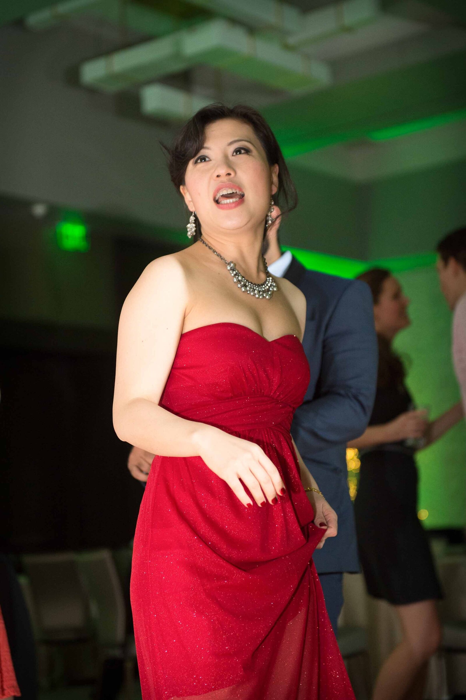 Holiday Party- Woman in Red Dress Dancing.-