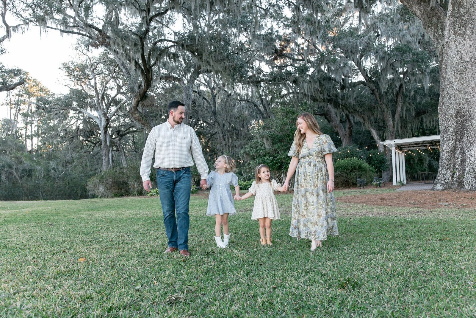 Family walking in park taken by Savannah family photographer Tiffany Bradley