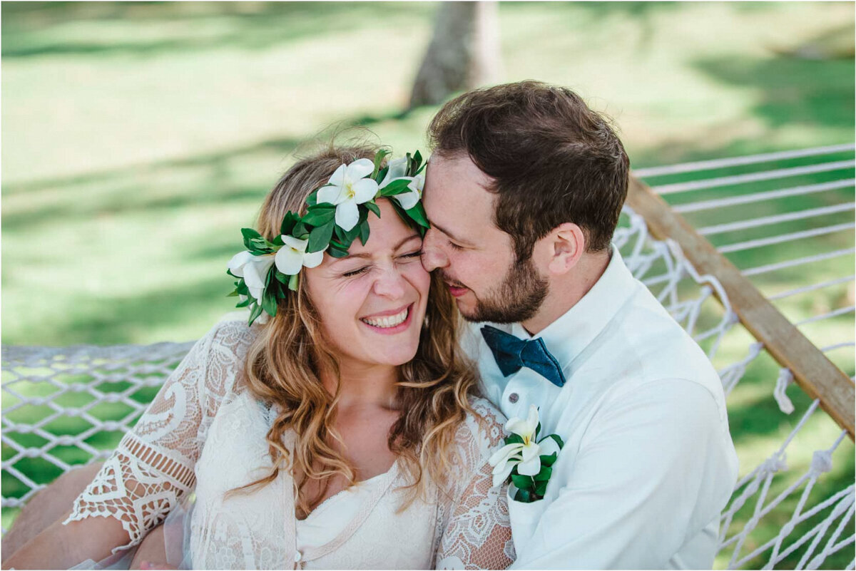 bride and groom snuggling in hammock