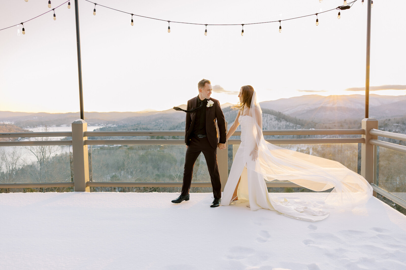 waterfall club sunset photo on the porch with string lights and covered in snow and north Georgia mountain views
