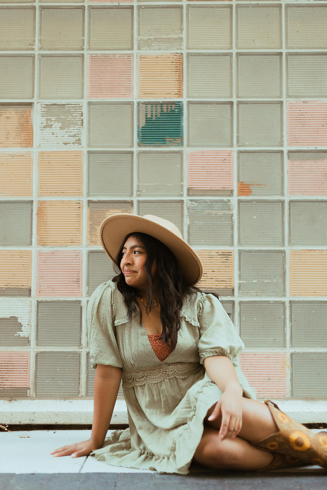 high school senior poses downtown for senior photos with ashley cole photography