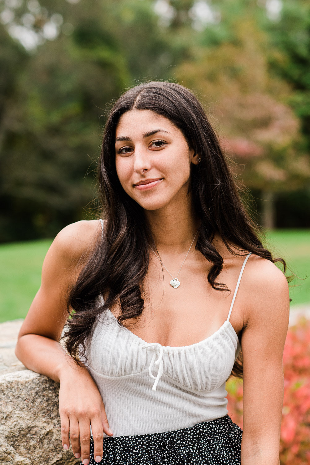 senior girl leaning on wall