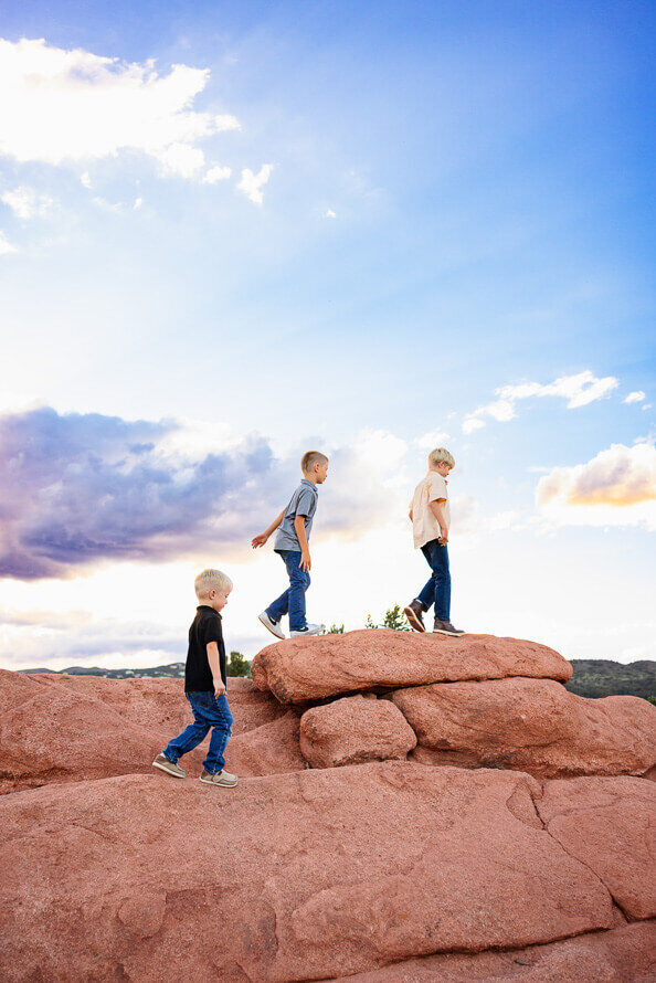 3 boys walk on the rocks in Garden of the Gods in Colorado Springs, Colorado.