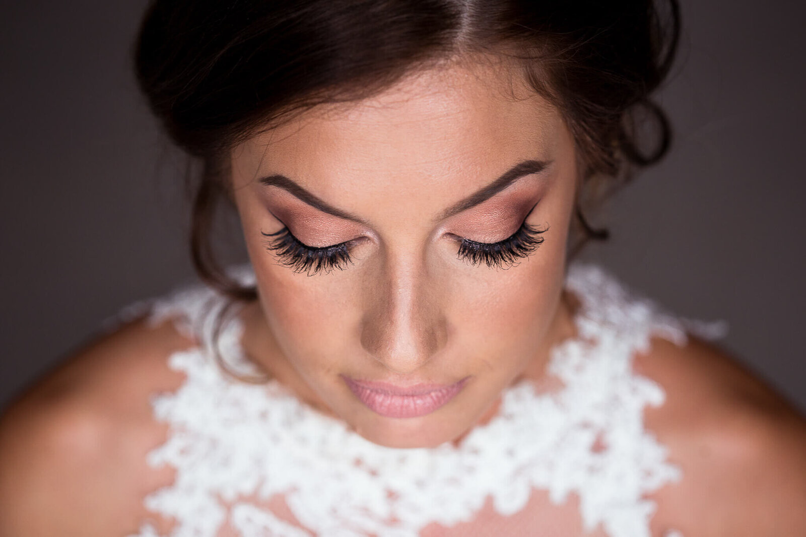 Closeup of bridal makeup and dress at Sydenham Ridge Estates.