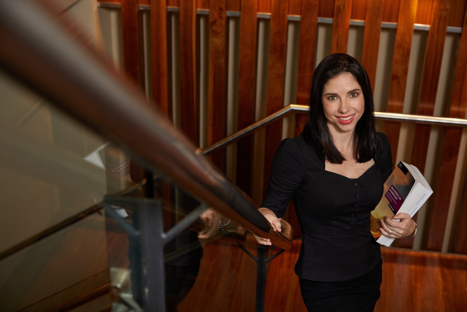 photo of business woman working up stairs at the shangri la cairns