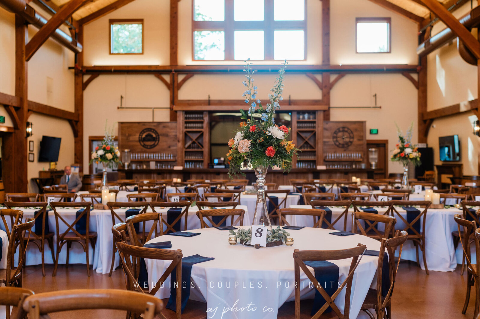 a table setting reception in the barn at the barnwood events in madison, winconsin
