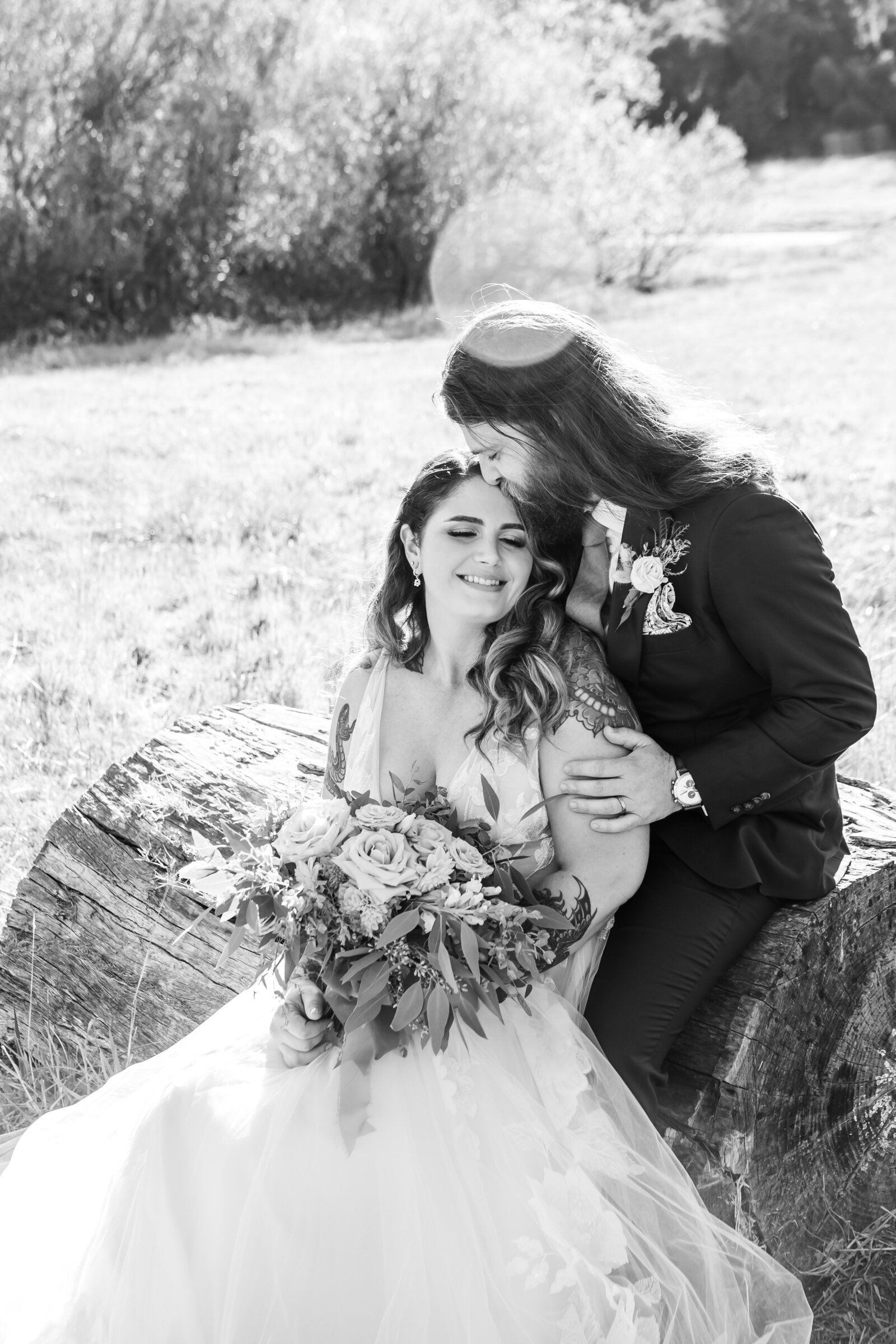 Tattoo bride and groom embrace on their colorful wedding day in Santa Cruz, California.