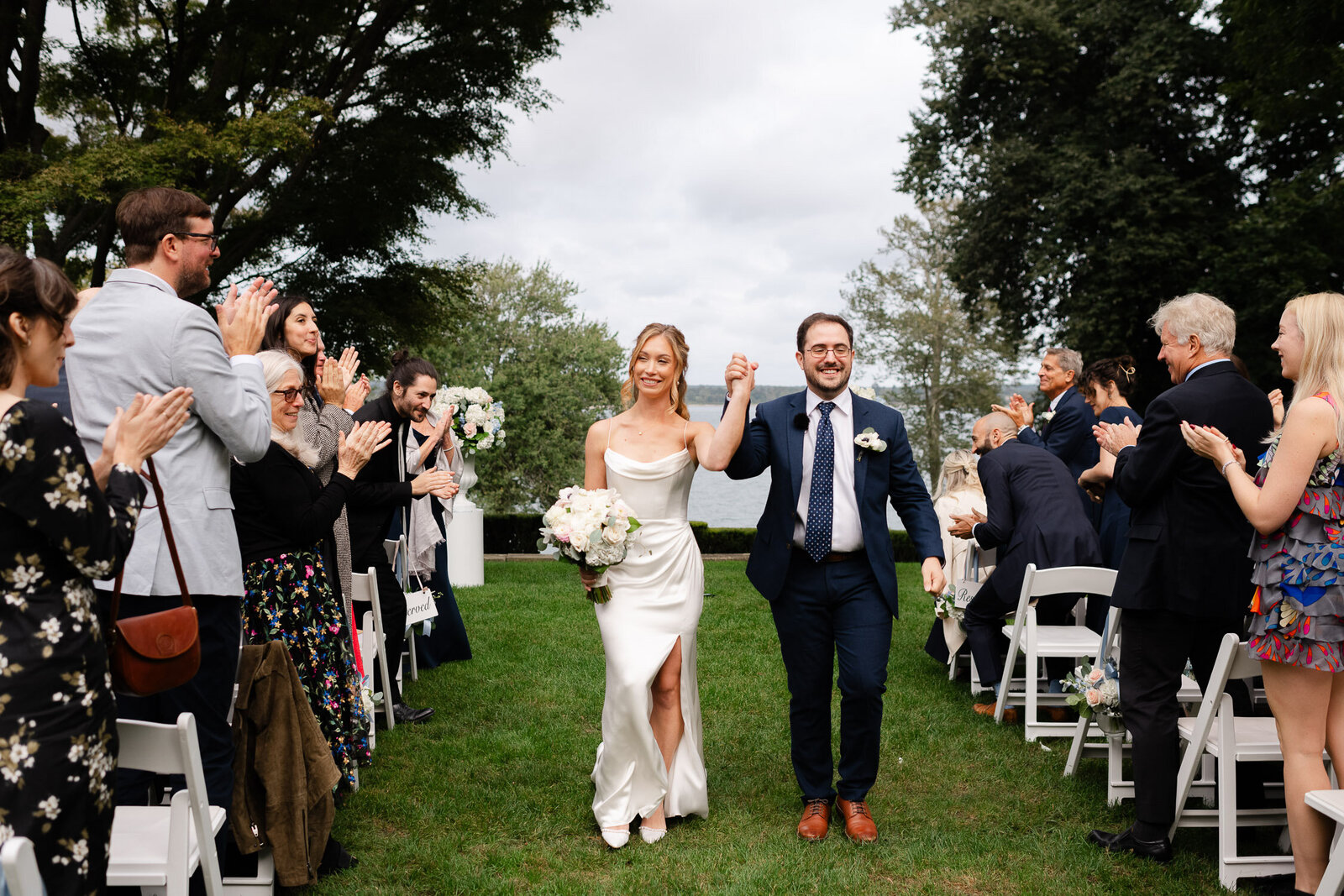 bride and groom recessional hold hands