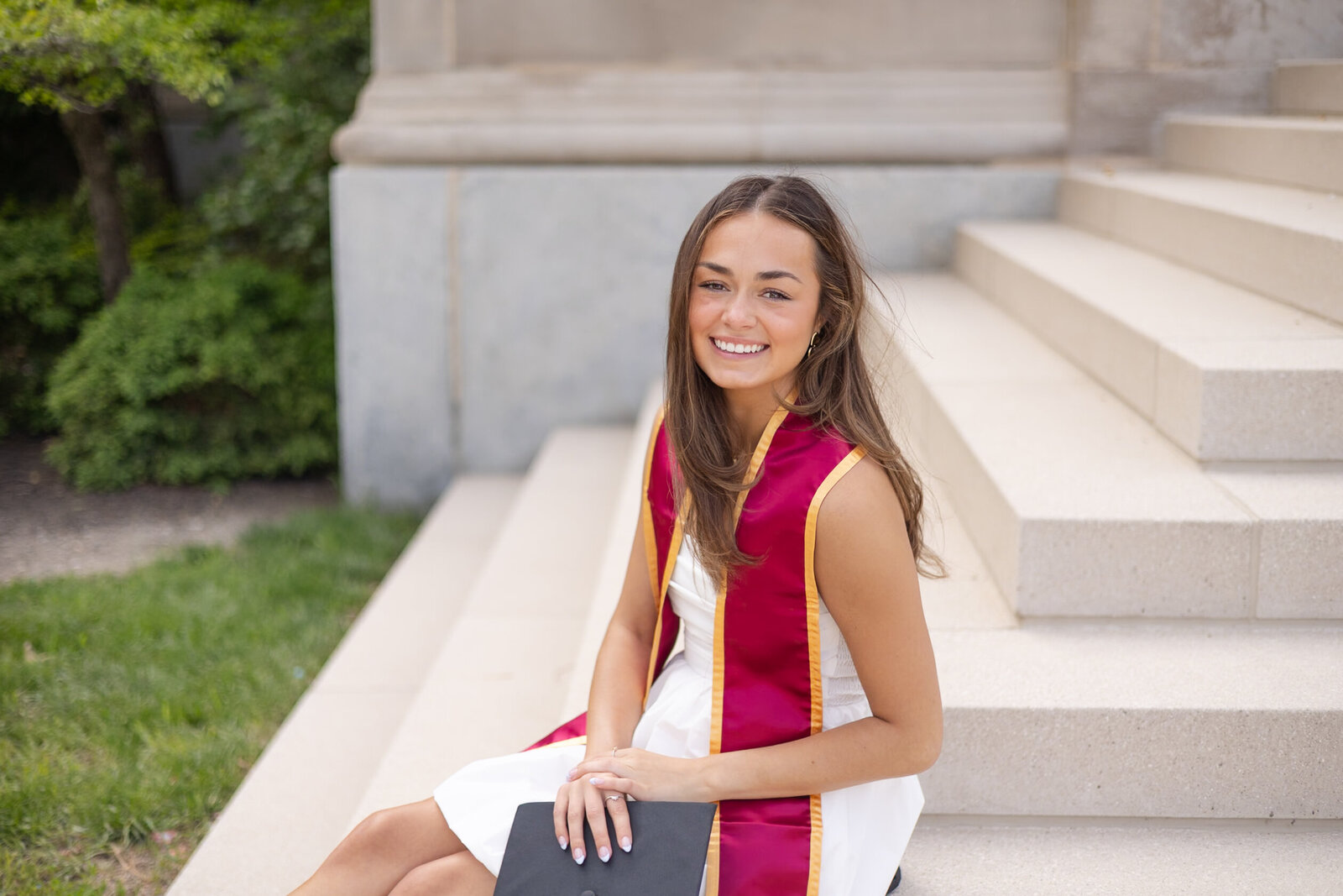 young woman poses for college graduate photo