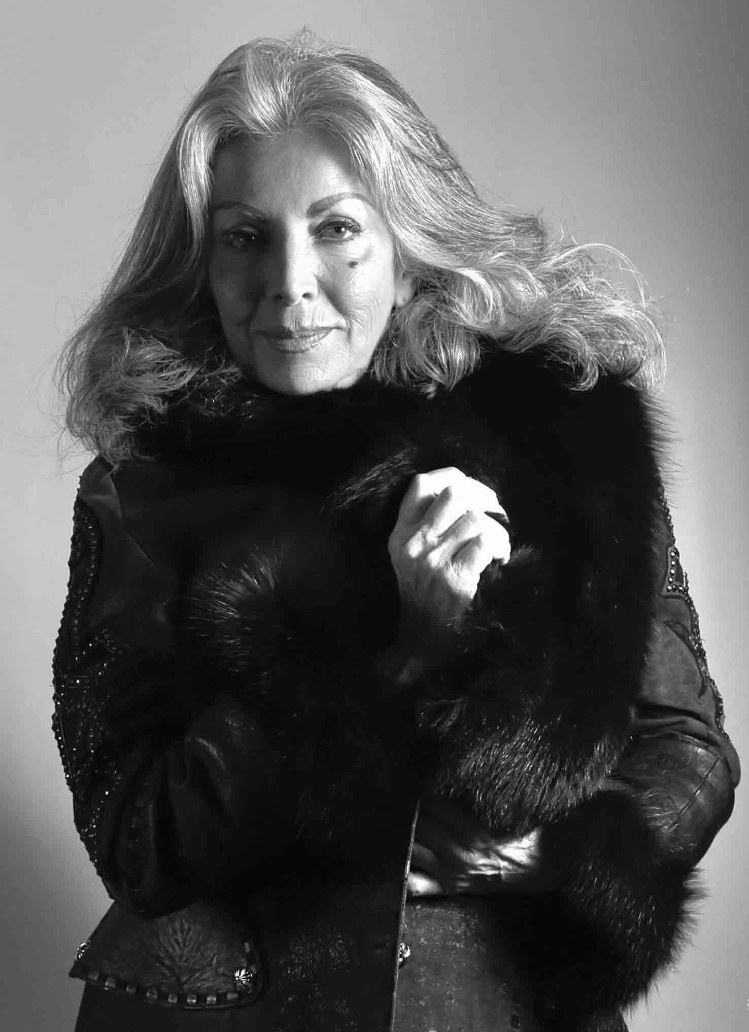 Black and white photo of a woman wearing a fur coat