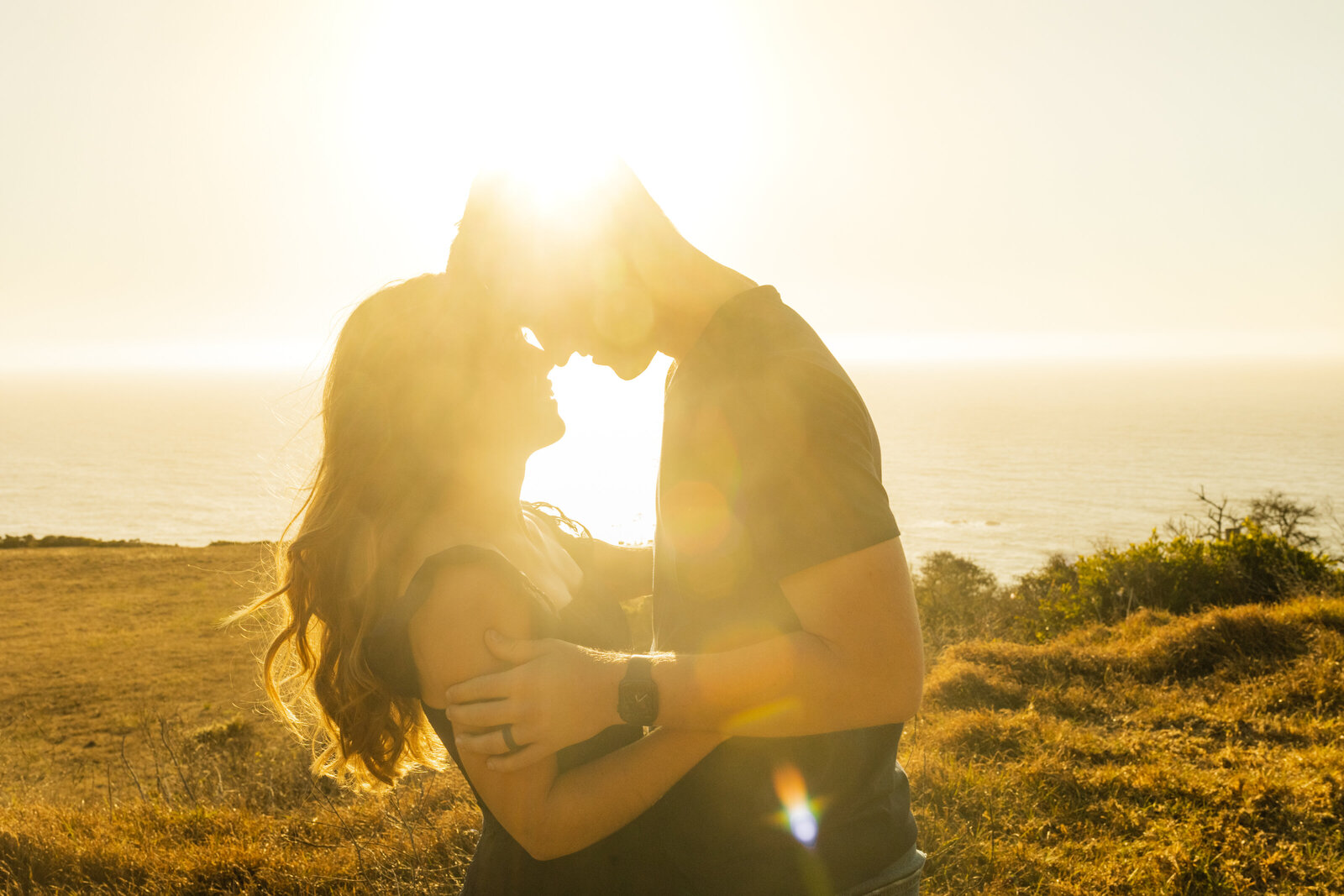 A couple poses for their engagement photos in Big Sur, California.