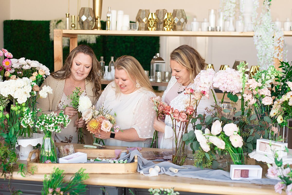 Natasha and her florists putting together bridesmaids bouquets in their Murfreesboro flower studio