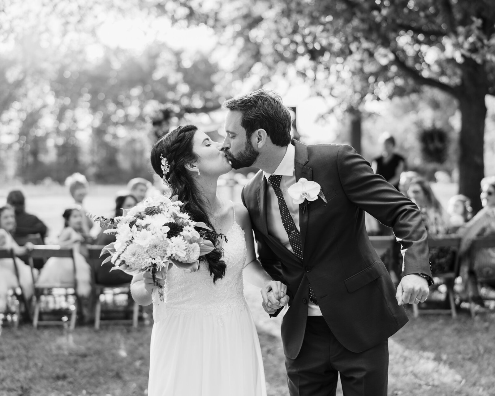 Bride and groom kiss after recessing down the aisle at Lane 57