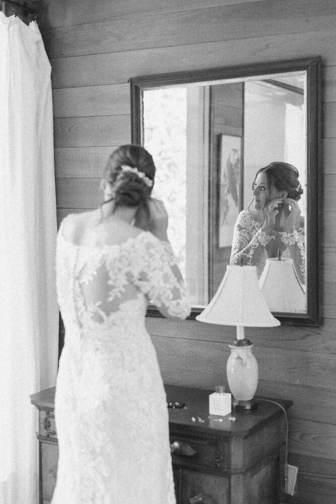bride putting in earrings