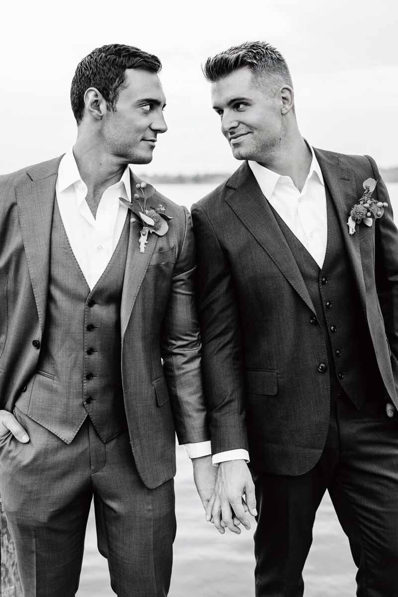 black and white photo of two men holding hands