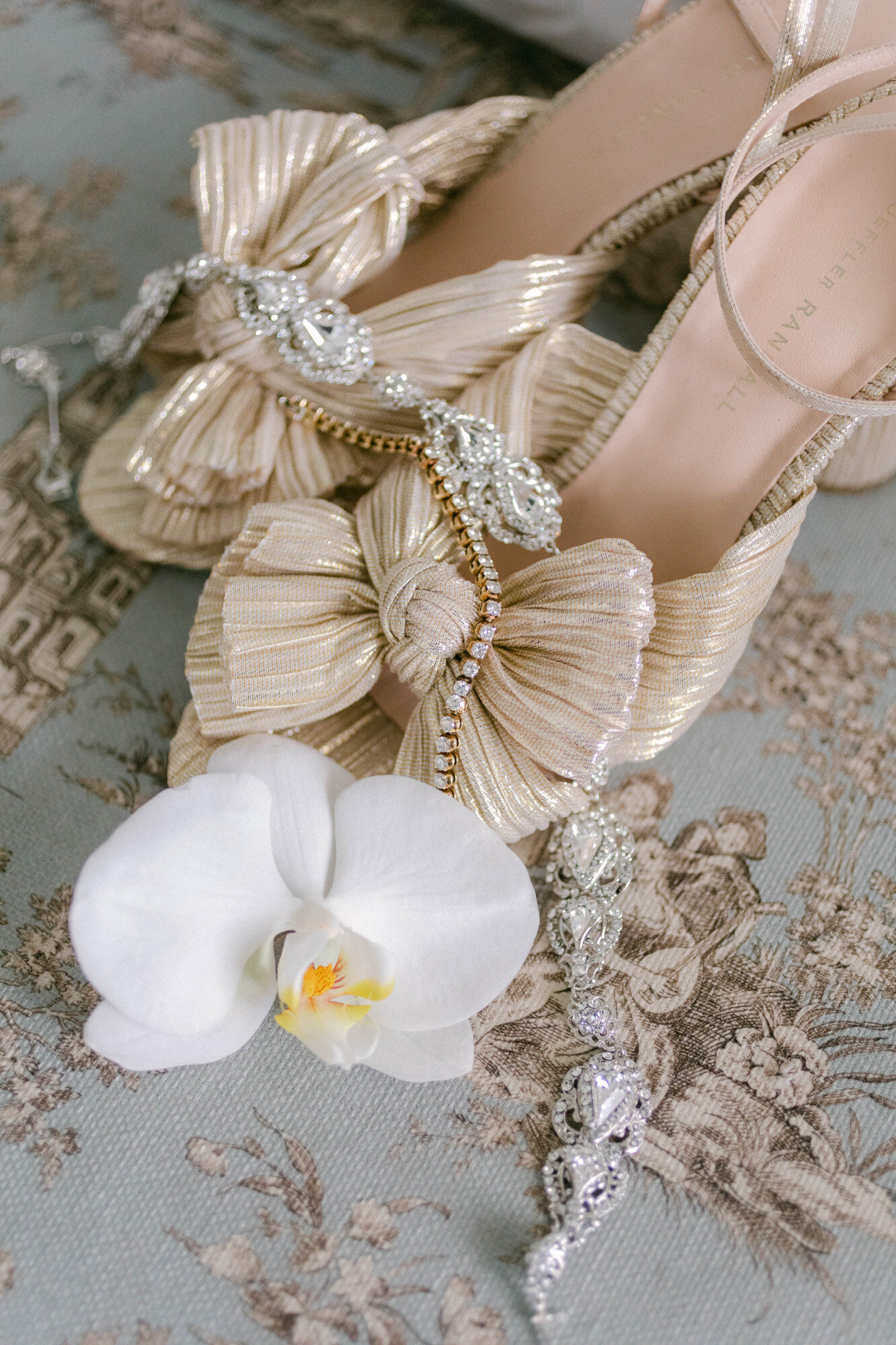 wedding shoes with jewelry and white floral