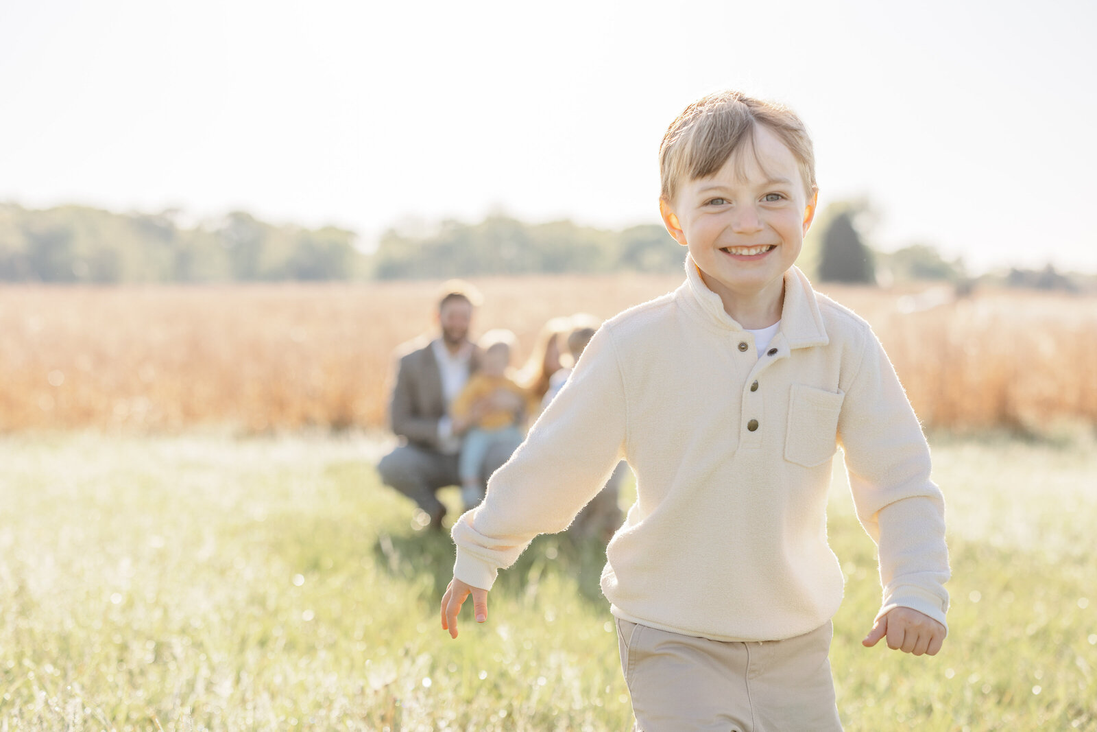 boy running away laughing during family session in Warrenton, Virginia
