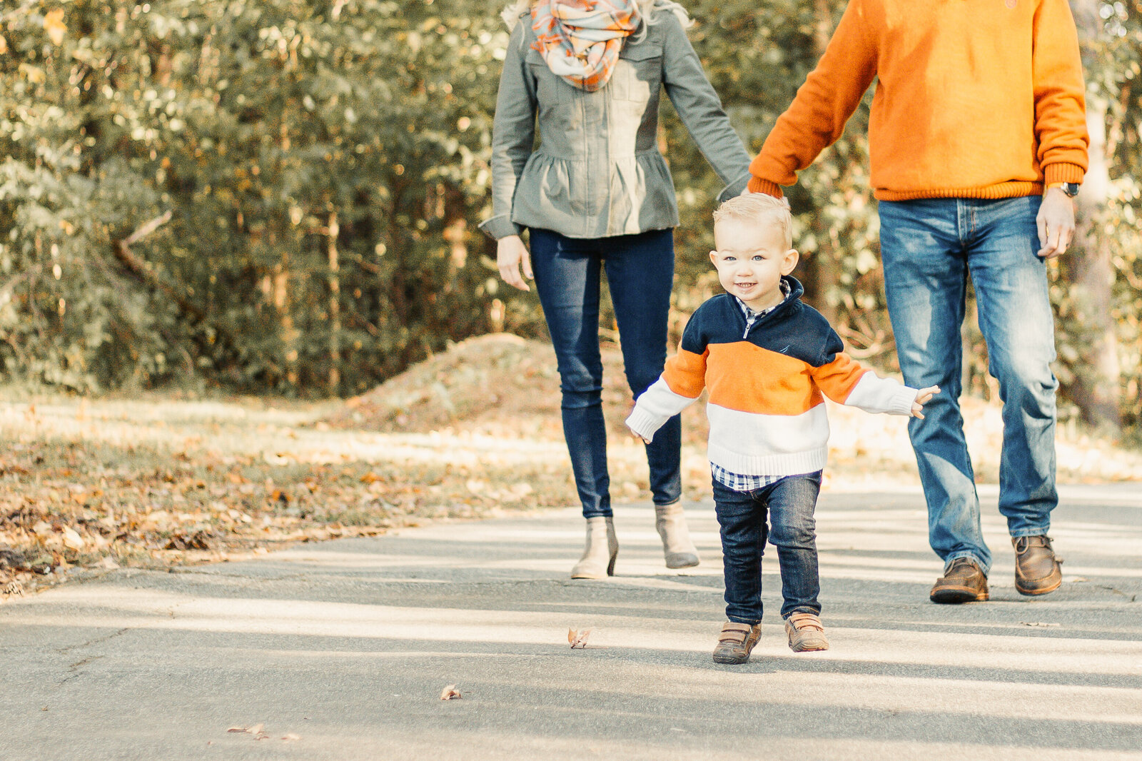 toddler running in family session in the fall