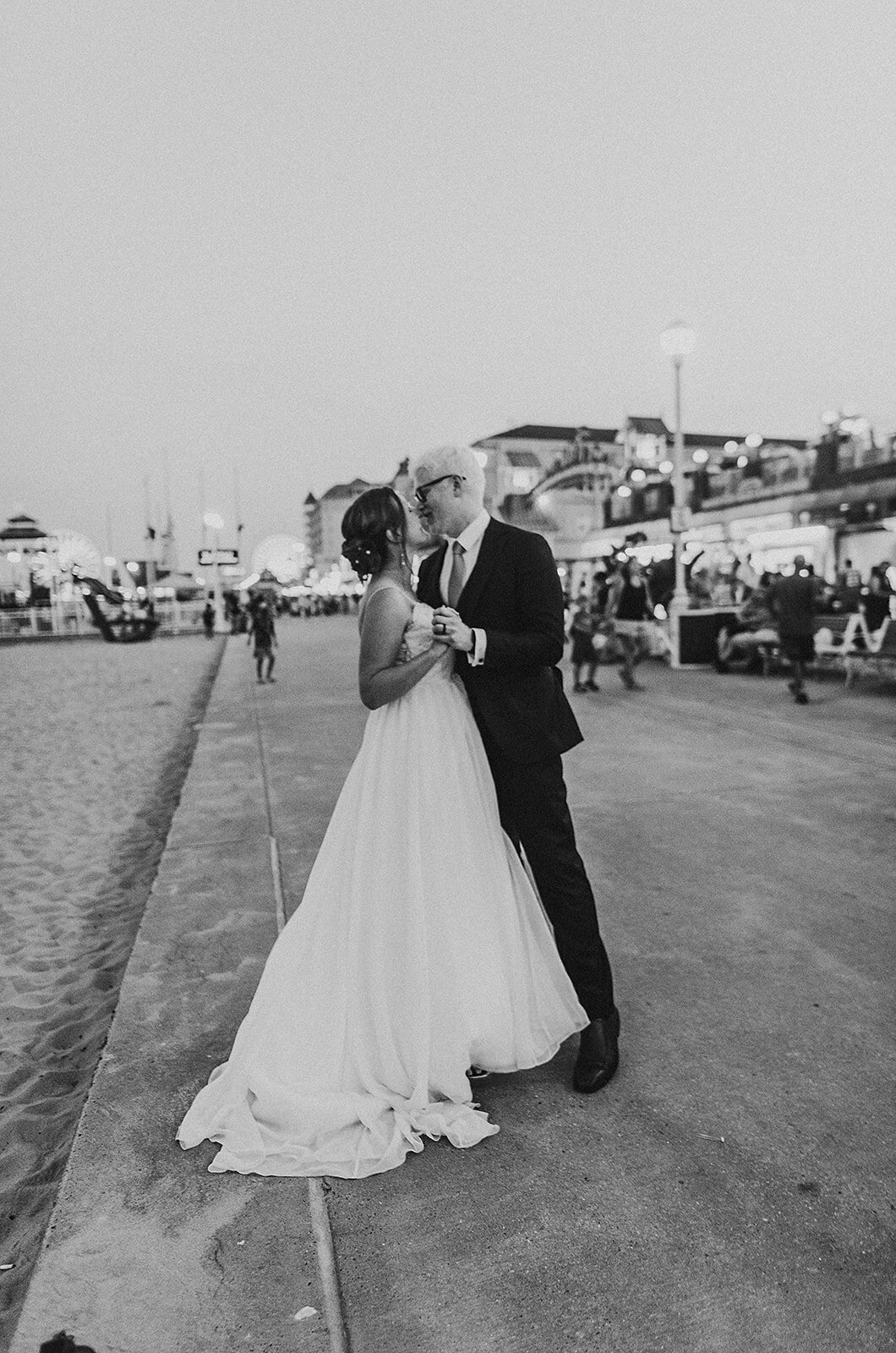 bride and groom share first dance at the beach to Taylor Swift