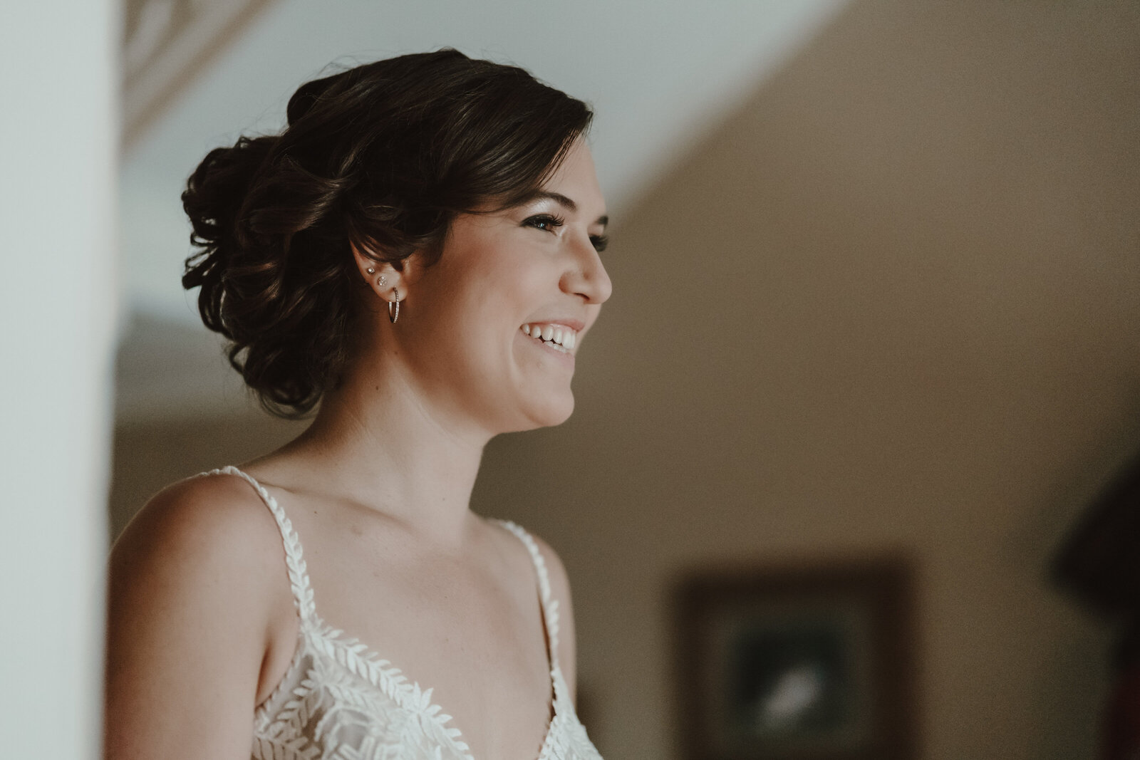 A bride smiles at the groom at their first look