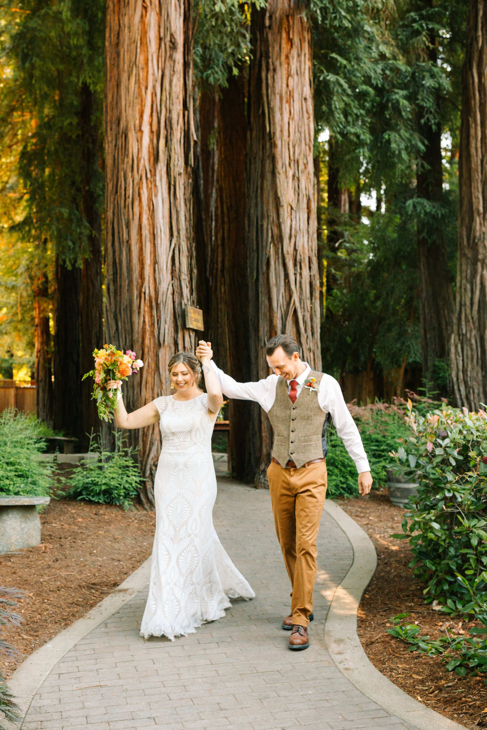 Bride and groom on their colorful wedding day in Santa Cruz, California in the redwood trees.