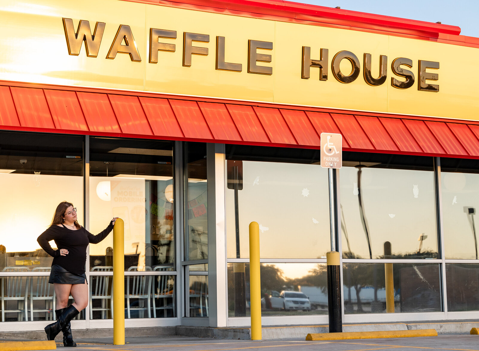 girl posing in front of waffle house