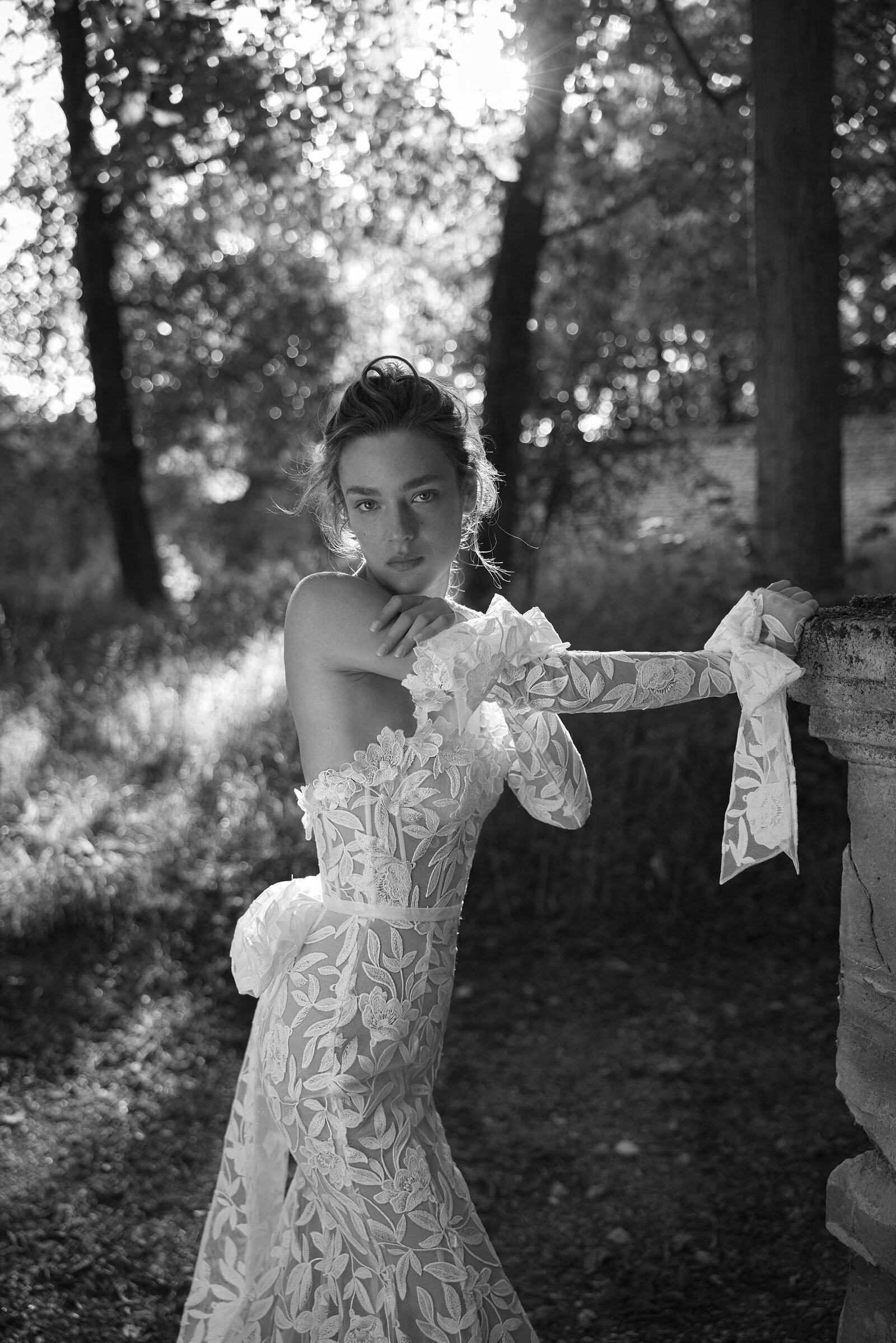 black and white image bride wearing strapless lace wedding dress with long sleeves