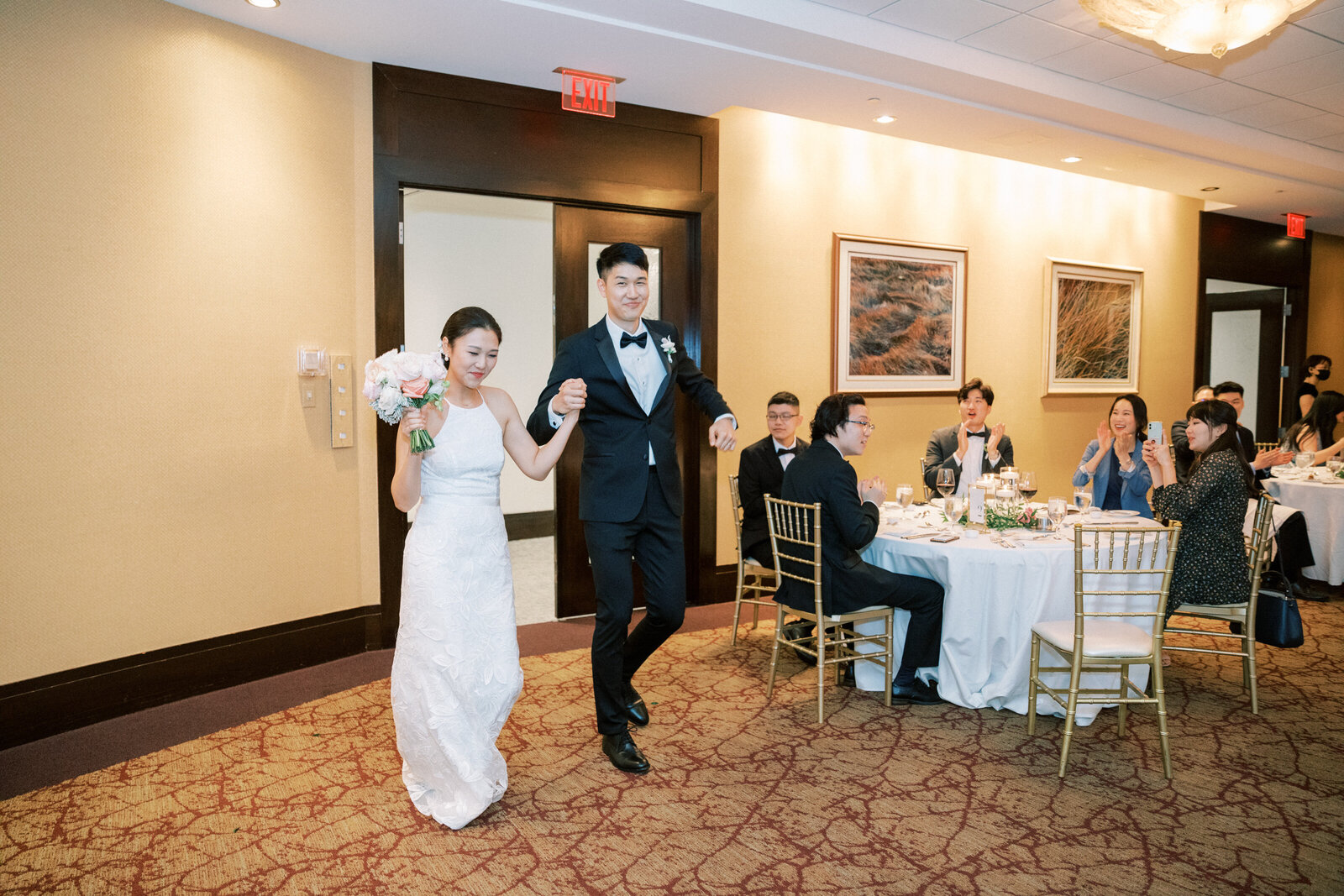 Bride and groom enter the reception cheering