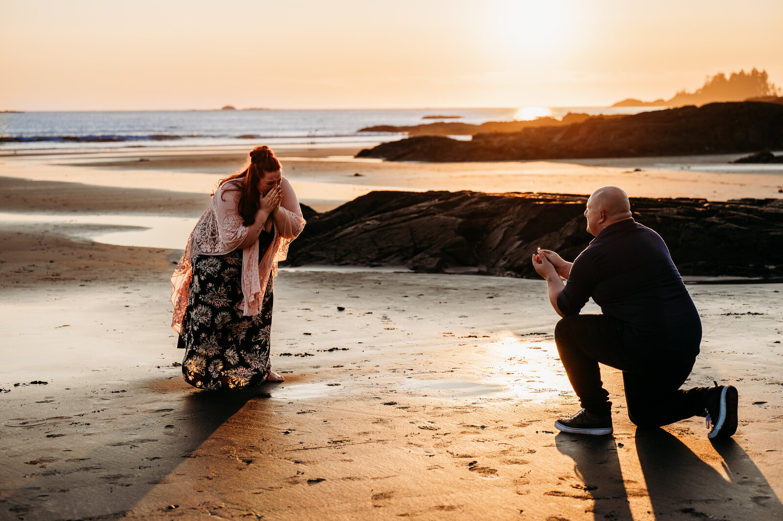 man proposes to his girlfriend on the beach in Tofino, BC