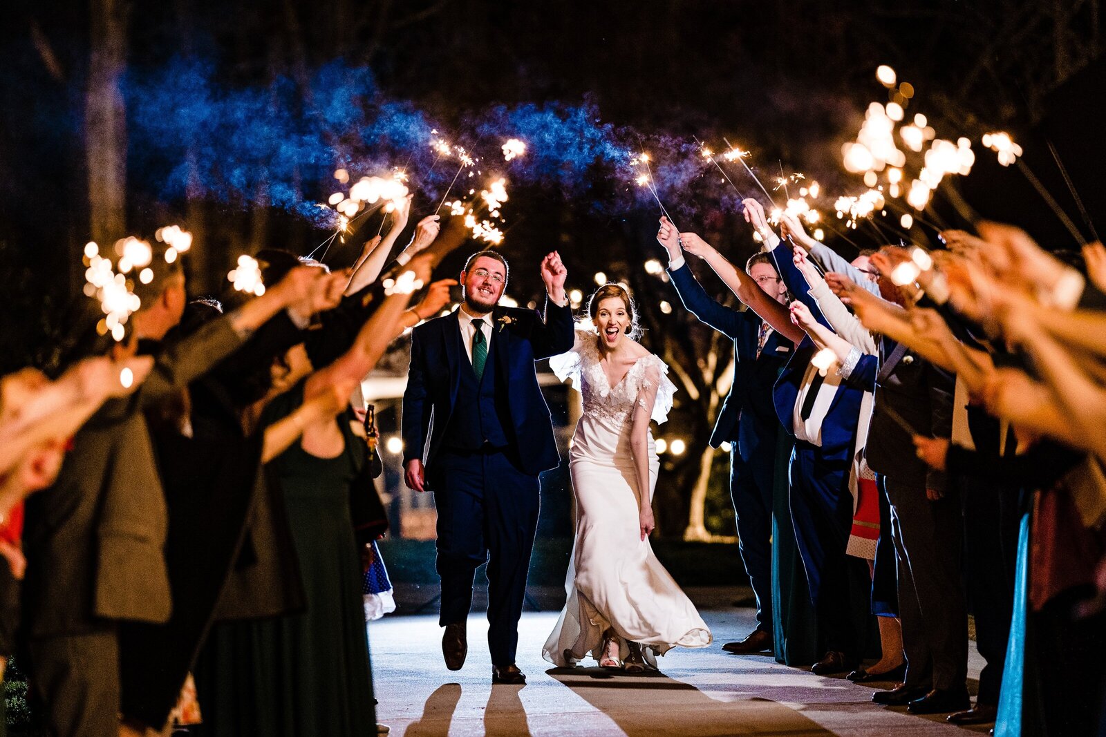 bride and groom exit through a sparkler tunnel at The Meadows in Raleigh, NC