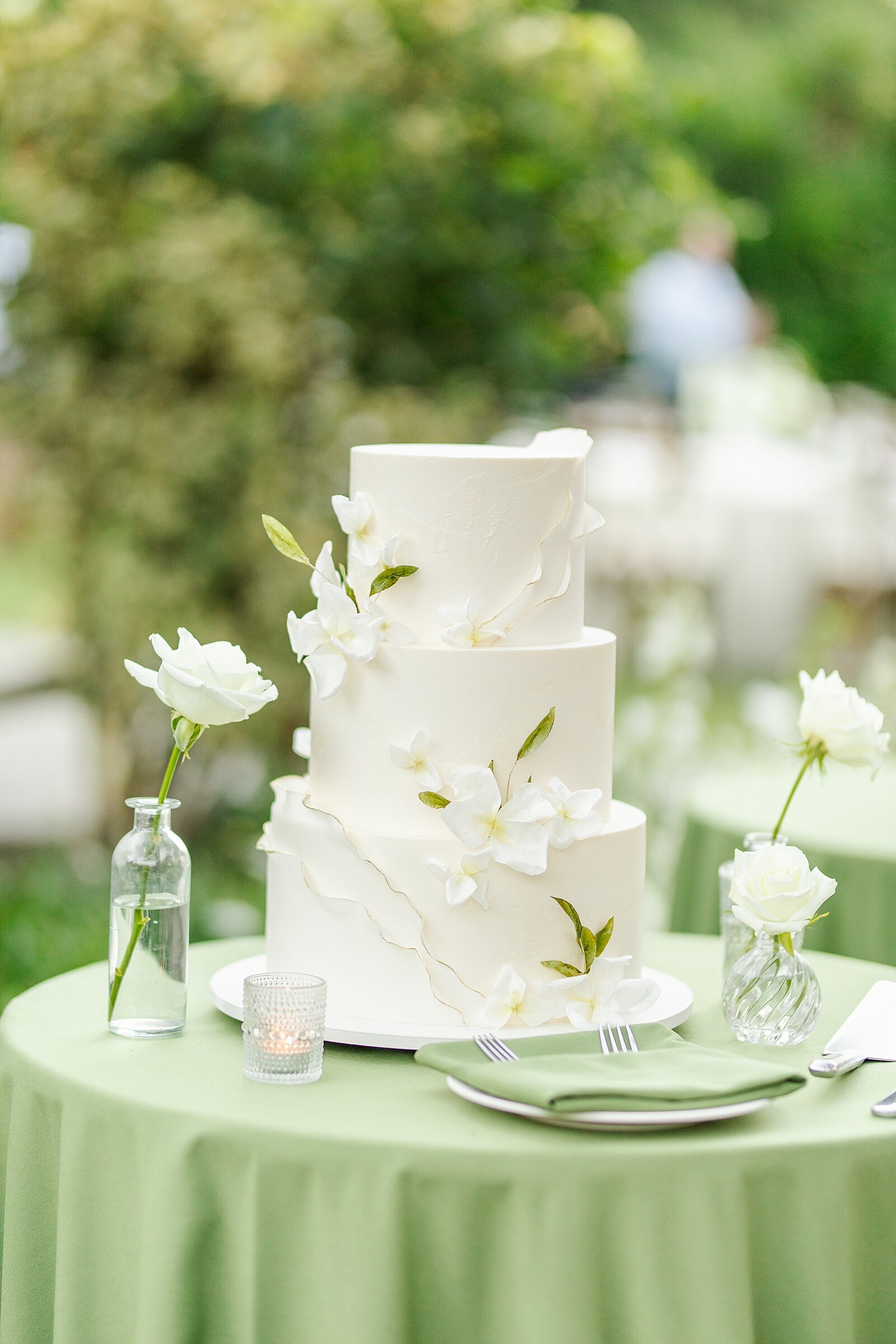 White floral wedding cake at Temecula Creek Inn Wedding photographed by Sherr Weddings.
