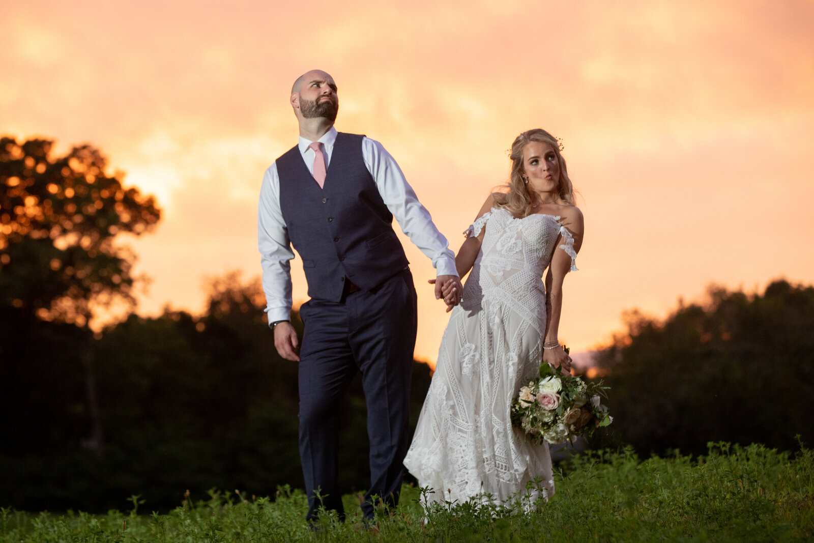 bride and groom in funny pose at sunset