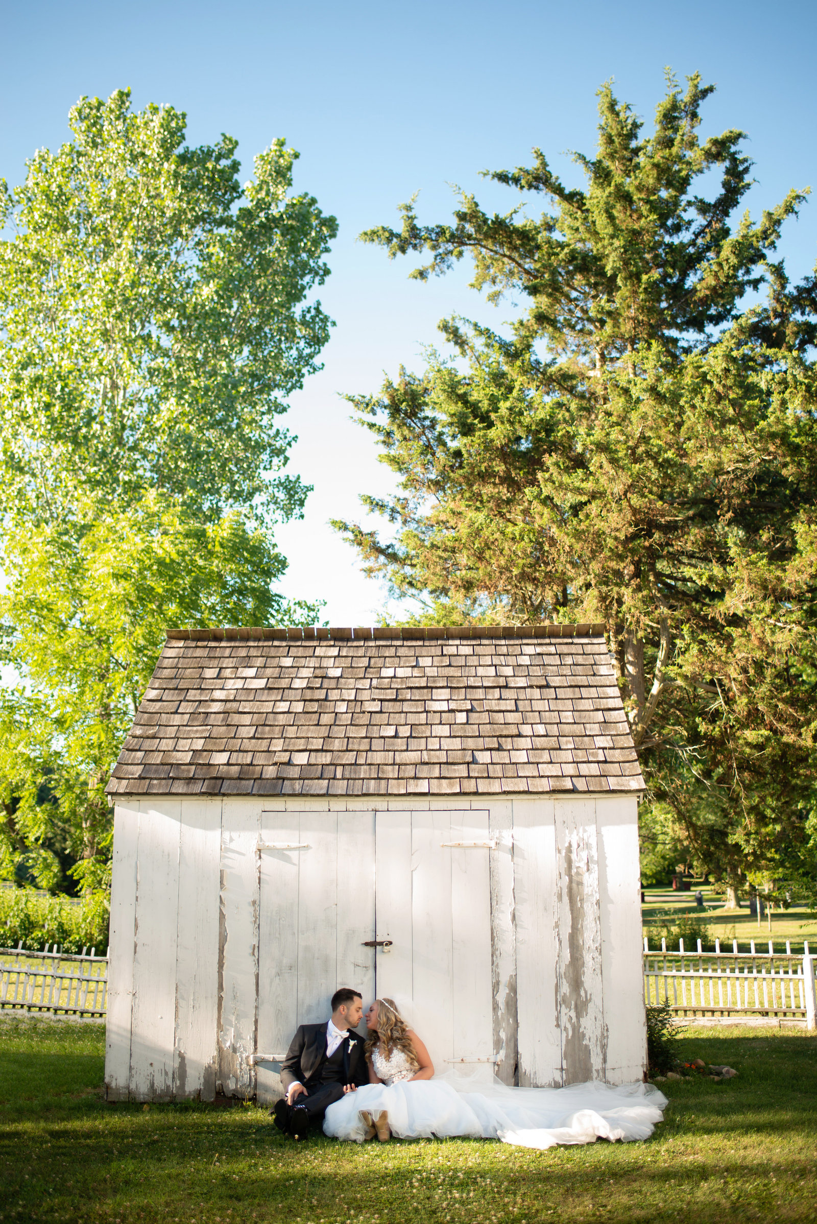 bride and groom posing in front of barn at The Barn in Old Bethpage