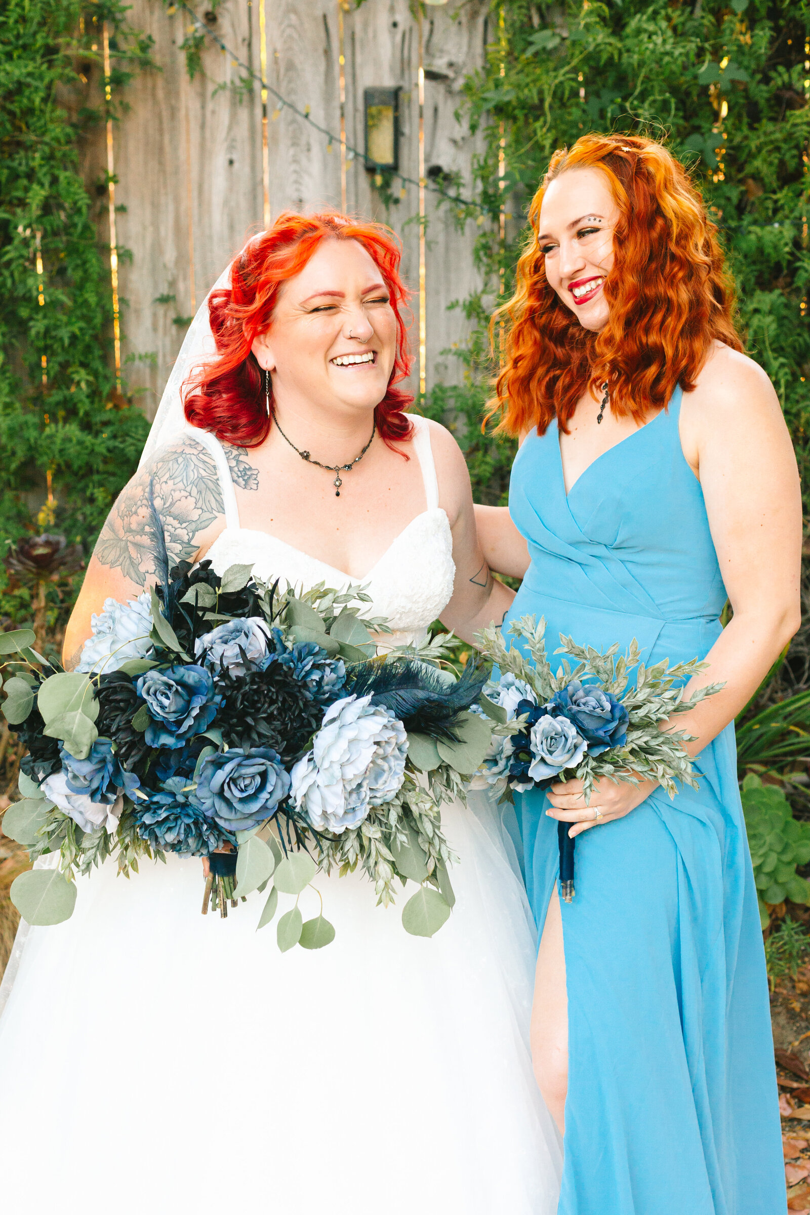 A bride and bridesmaid with red hair and blue details.