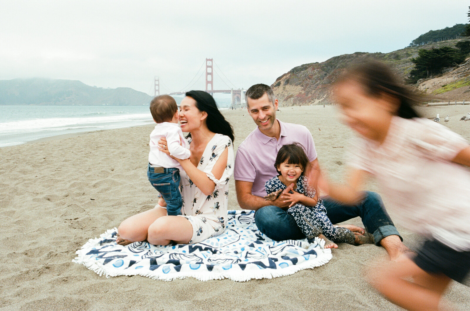 photo of family of 5 including the golden gate bridge at baker beach