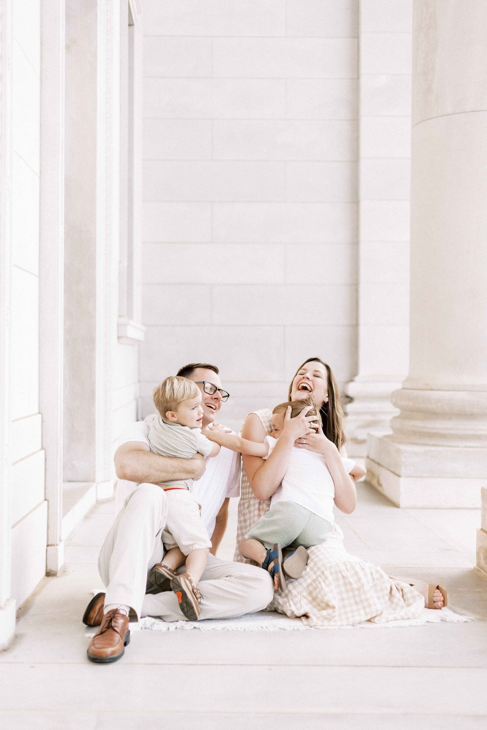 kids hugging parents and laughing in maternity photos in peoria illinois 
