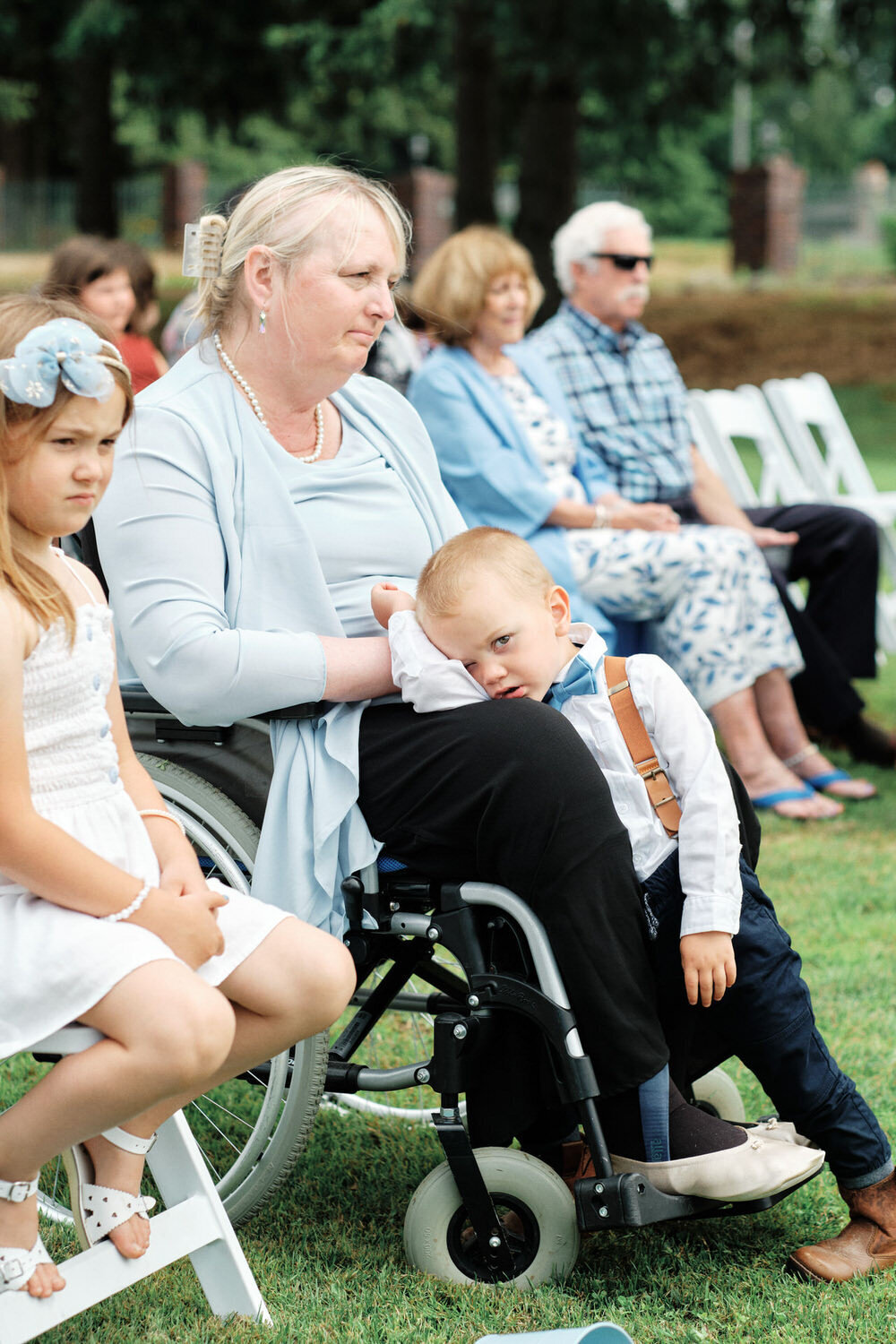 Ring bearer lays his head in his grandmother's lap